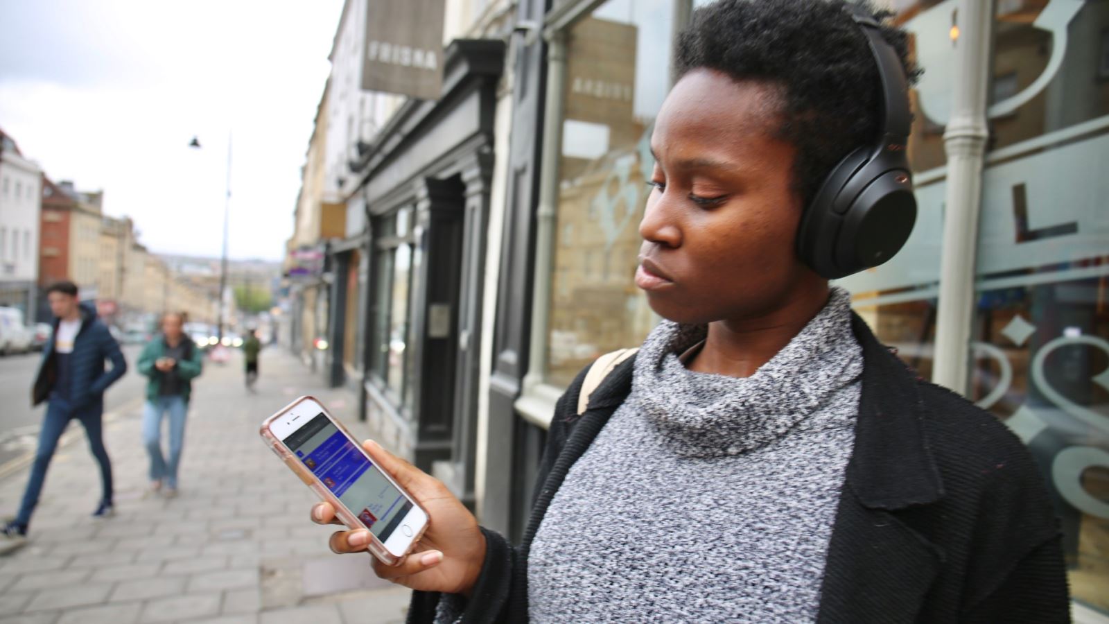 Woman listens to Everything is Music on her phone via headphones